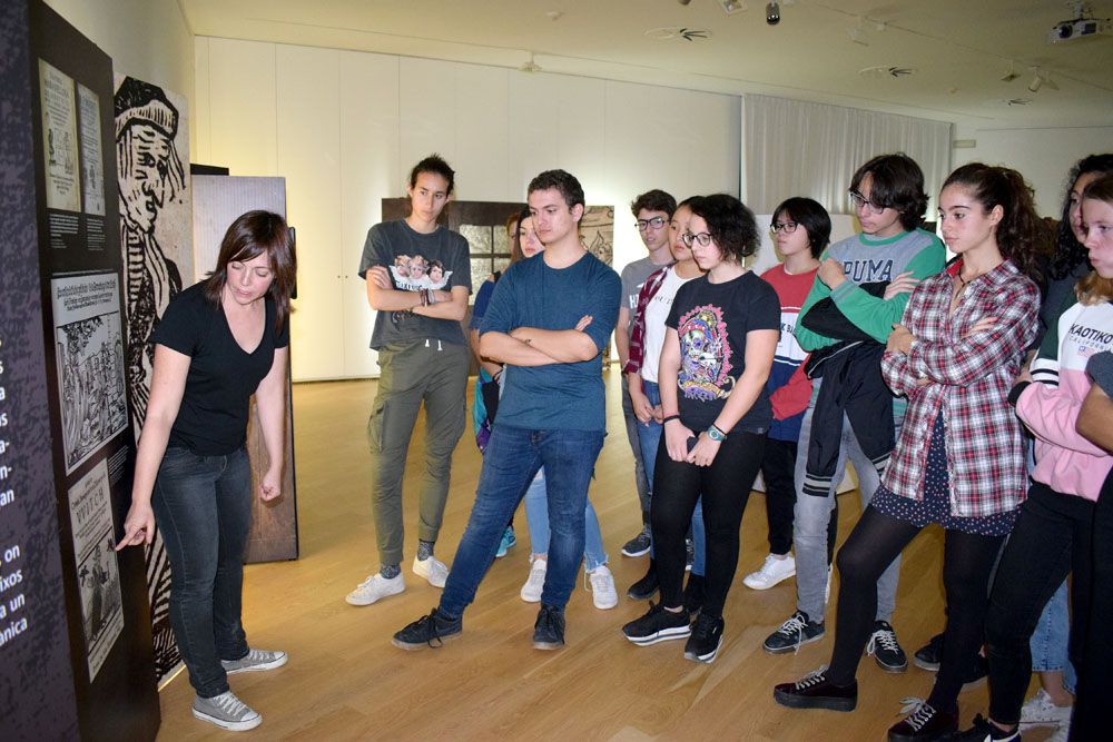 Els joves participants escolten les explicacions de la tècnica del Museu de ca n'Oliver